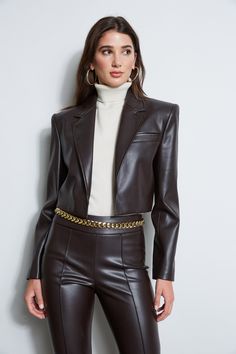 Meet the next "it " blazer. Cropped, bold shouldered, with stacked buttons sleeve detail, it has the ultimate cool factor! Designed in our Luxe Vegan Leather, Elie loves it paired as a suit with its matching vegan leather pant or skirt or as a great item jacket throughout your wardrobe. Elie Tahari Exclusive Vegan Leather Cropped Jacket 50% Polyester, 50% Polyurethane Runs true to size. Model is 5'9" and wearing size 2 Length From Shoulder to Hem: Sleeve 24.5"L, Back 17" L (approx. length for si Vegan Leather Pant, Satin Suits, Elegant Office Wear, Cropped Leather Jacket, Leather Pant, Vegan Leather Jacket, Elie Tahari, Leather Outfit, Leather Blazer