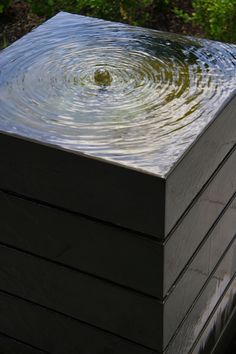 a wooden box with water swirling around it