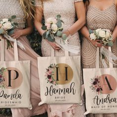 four bridesmaids are holding their bouquets and tote bags in front of them