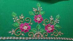 a tiara with pink flowers and green leaves on the front, sitting on a table