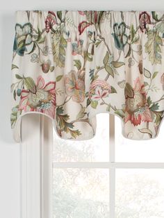 a window with a flowered valance hanging from it's side