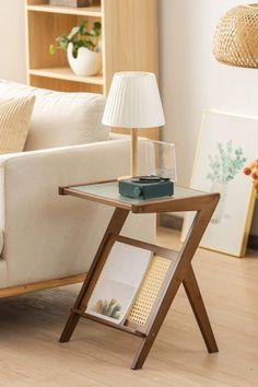 a living room with a couch, table and lamp on the floor in front of it