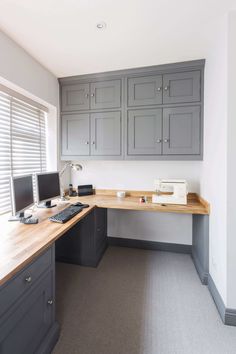 an office with gray cabinets and wooden desk