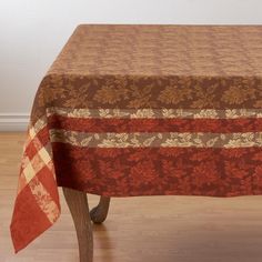 a red and brown table cloth on top of a wooden chair