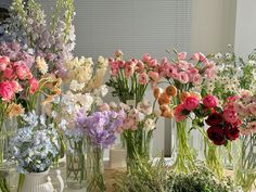 several vases filled with different types of flowers