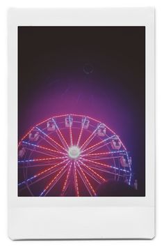 a ferris wheel is lit up at night