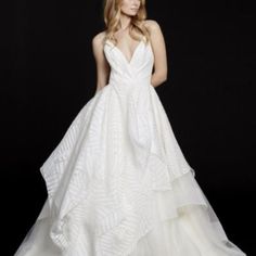 a woman in a white wedding dress posing for the camera