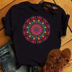 Embrace the essence of peace and harmony with our Mandala Zen Harmony Tee. Featuring a captivating mandala design, this shirt is a wearable symbol of the balance and meditation central to yoga practice and beyond. This versatile piece is not just for the yoga mat; it's designed for any woman who values comfort, style, and a hint of the spiritual in his daily wear. The mandala, an ancient symbol used in various traditions to represent the universe, is intricately designed to inspire focus and inn Black Bohemian T-shirt For Festival, Black Bohemian T-shirt With Relaxed Fit, Black Bohemian Relaxed Fit T-shirt, Summer Care, Mandala Floral, Cartoon Clothing, 90s Tees, Casual Shirt Women, Cartoon Outfits