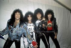 the band kiss posing in front of a white backdrop