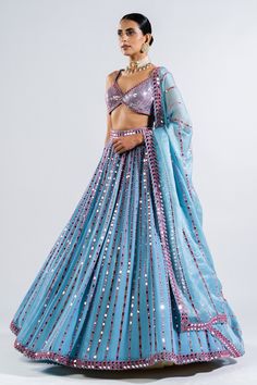 Ice blue lehenga with mirror embroidery in a stripe pattern and multicolor thread work. Comes with sequin embroidered blouse and border embroidered dupatta.
Components: 3
Pattern: Embroidery
Type Of Work: Mirror and Sequin
Neckline: V neck
Sleeve Type: Sleeveless
Fabric: Lehenga and Blouse- Georgette and Dupatta: Satin Organza
Color: Blue
Other Details: 
Low back with tie up and tassels
Dupatta with mirror embroidered border
Closure: Back hook
Note: Choker worn by the model is not for sale
Occas Tassels Dupatta, Mehendi Outfit, Lehenga Dupatta, Mirror Work Blouse, Full Sleeve Blouse, Mirror Embroidery, Georgette Dupatta, Metallic Blouses, Blue Lehenga