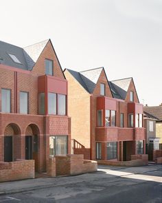 some red brick buildings with windows and balconies