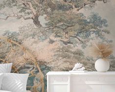 a bedroom scene with focus on the wallpaper and bedding that has a large tree painted on it