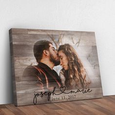 a wooden sign with a photo of a man and woman kissing on the foreheads