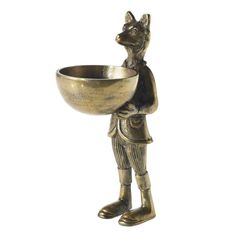 a gold colored metal bowl with a dog holding it