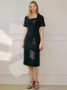 This product is a Lucy Tweed Dress that combines classic elegance with a modern, streamlined silhouette. The dress showcases a subtle texture, offering a tactile dimension to its simple yet sophisticated shape. Designed with short sleeves and a midi length, it strikes a balance between coverage and style, making it a versatile choice for various occasions. - The dress features a refined texture characteristic of tweed, delivering both visual interest and a timeless appeal.- Its straight cut and midi length cater to a sophisticated aesthetic, suitable for formal events or office wear.- The short sleeves provide a demure touch while keeping the dress suitable for warmer seasons or layered combinations.- This tweed dress is a chic, multipurpose garment that can be accessorized to fit bot Fitted Short Sleeve Tweed Dress For Evening, Chic Short Sleeve Tweed Dress For Formal Occasions, Chic Short Sleeve Tweed Evening Dress, Elegant Fitted Short Sleeve Tweed Dress, Elegant Short Sleeve Tweed Dress, Elegant Midi-length Tweed Dress For Office, Elegant Midi Length Tweed Dress For Office, Elegant Midi Tweed Dress For Office, Formal Short Sleeve Tweed Dress