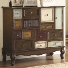 an old dresser with many drawers and pictures on top