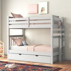 a white bunk bed with drawers underneath it in a child's playroom or bedroom