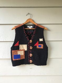 "Beautiful and unique vintage thick acrylic knit vest with leather stitching and decorative patching. Buttons are a unique carved wood with leather button loops. Size small. Great vintage condition. Please see photos for details. Flat Measurements: Shoulder to Hem 20\" Chest 18\" Waist 18\"" Vest Outfits, Knit Vest, Womens Vest, Unique Vintage, Carving, Outfit Inspo, Knitting, Clothes For Women, Crochet