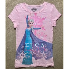 Embrace The Magic Of Disney's Frozen With This Elsa Snow Queen T-Shirt. This Adorable Pink Shirt Features Elsa, The Beloved Character Who Captured Our Hearts In The Hit Movie. Perfect For Any Little Girl Who Loves Frozen, This T-Shirt Is A Must-Have Addition To Her Wardrobe. It Comes In Size Xl And Is Brand New, Never Been Worn. The Shirt Is Made With High-Quality Materials, Ensuring That It Is Both Comfortable And Durable. With Its Vibrant Colors And Charming Design, Your Child Will Love Wearin Elsa Disney Shirt, Elsa Tshirt, Frozen Birthfay Shirt, Pink Disney Character Print T-shirt, Frozen Shirts, Xl Girls, Queen Tshirt, Disney Frozen Elsa, Snow Queen