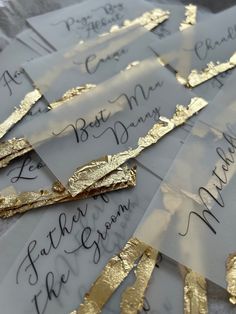 several envelopes with gold foil on them and some handwritten letters in black ink