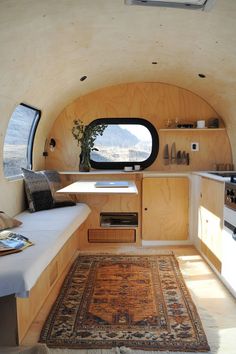 the interior of a tiny home with an oval window