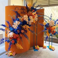 an orange and blue display with flowers on it