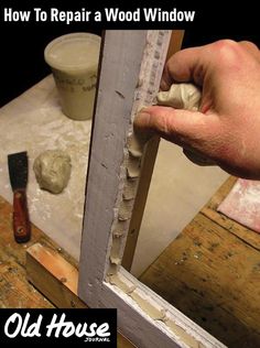 an old house window being worked on with the help of a man's hand