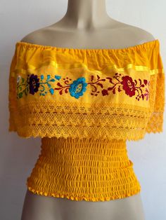 100% Authentic Mexican Shirt This Shirt is gorgeous. Material: 85% cotton 15% acrilic Color: yellow Size:One size fit most  This blouse is with elastic an the waist  Ebroidery Mexican shirt Please take a good look an the picture to see if this is the color your looking for. Folk Fabric Flowers Mexican Tunic Traditional Embroidery This shirt is perfect for any occasion This Shirt is meant to provide extreme comfort throughout the day Fitted Off-shoulder Yellow Tops, Yellow Fitted Off-shoulder Tops, Cotton Off-shoulder Tops With Floral Embroidery, Off-shoulder Cotton Top With Floral Embroidery, Cotton Embroidered Off-shoulder Tops, Embroidered Off-shoulder Cotton Tops, Yellow Embroidered Tops For Festival, Yellow Embroidered Festival Tops, Fitted Off-shoulder Embroidered Top