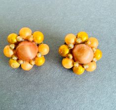 Pair of vintage clip on earrings from 1940s costume jewelry. Some scratches on the faux pearls. Clips work good. See pic for measurements. Vintage Orange Clip-on Earrings, Vintage Orange Beaded Earrings, Orange Beaded Vintage Earrings, 1940s Costume, Vintage Clip, Costume Jewelry, Faux Pearl, Clip On Earrings, Beauty Book