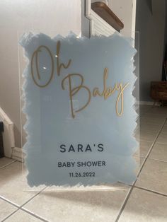 a glass sign that says oh baby sara's baby shower