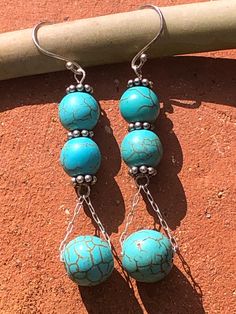 Southwestern Style, Beautiful Turquoise, round, stone beads, 7 mm and 11 mm. 925 Sterling Silver Ear Hooks,  925 Sterling Silver decorative Rondelle spacer beads. 925 Sterling Silver chain and earring stems. Cheap Turquoise Earrings With Dangling Beads, Artisan Dangle Jewelry With Spacer Beads, Artisan Jewelry With Dangle Spacer Beads, Silver Beaded Earrings With Natural Stones, Silver Gemstone Beads Earrings, Silver Earrings With Gemstone Beads, Turquoise Beaded Earrings With Natural Stones, Sterling Silver Gemstone Bead Earrings, Silver Earrings With Gemstone Round Beads