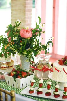 a table topped with lots of cakes and desserts