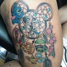 a tattoo on the leg of a person with a dog and dream catcher in it