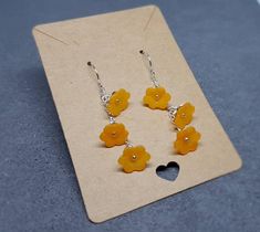 ORANGE OPEN FLOWER EARRINGS * Handmade orange flower earrings * Frosted orange lucite acrylic flowers measuring 11mm x 4.5mm * Individual wire wrapped * Silver plated components (chain, bead caps, wire) * Also available in other colours, please see my shop * Choice of ear wires * Rubber earring stops * Optional sterling silver ear wires are high quality solid 925 sterling silver hallmarked and a sturdy 0.8mm gauge TIME IT TAKES TO MAKE YOUR ITEM * Every single item is handmade to order with the Orange Flower-shaped Adjustable Earrings, Orange Flower-shaped Earrings For Gift, Nickel-free Orange Flower Earrings, Orange Adjustable Dangle Flower Earrings, Yellow Earrings With 3d Flowers As A Gift, Orange Dangle Flower Earrings Gift, Orange Dangle Flower Earrings For Gift, Orange Drop Earrings For Gift, Orange Dangle Flower Earrings With Ear Wire