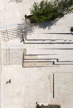 an aerial view of a park with benches and trees