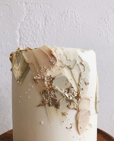 a close up of a cake with frosting and other things on it's surface