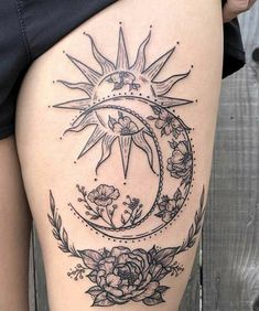 a woman's thigh with a sun and moon tattoo on it