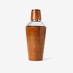 a wooden flask with a metal lid on a white background, the top is made out of wood and has a stainless steel cap