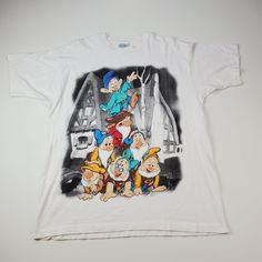 a white t - shirt with an image of cartoon characters on it