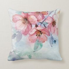 a watercolor pillow with pink flowers on it