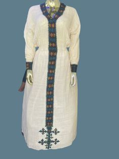 Fetel dress from axum Tigray Ethiopia. It's hand woven from an organic cotton and hand embroidered. The dress is very graceful and can be worn for a wedding, christening and holidays.  Please add your measurements when placing your order.  Since it's hand embroidered it takes about a month to make unless we have a ready-made one in your size delivery might take 4-6 weeks. White Folk Dress With Weaving Work, Elegant Dresses With Embroidered Border For Traditional Ceremonies, White Bohemian Embroidered Dress With Woven Motifs, Bohemian White Embroidered Dress With Woven Motifs, Elegant Handmade Fitted Dresses, Folk Style Handwoven Cotton Dress, White Folk Embroidered Dress With Woven Motifs, Elegant Spring Dress With Embroidered Border, Traditional White Handwoven Dress