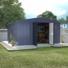 a blue shed sitting on top of a lush green field