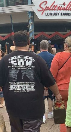 people are walking down the sidewalk in front of a sun restaurant and bar on a sunny day