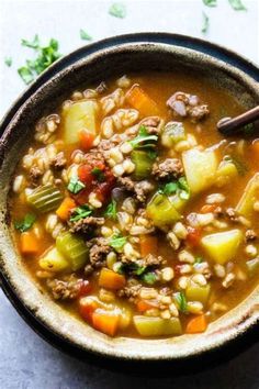 a bowl of soup with meat and vegetables