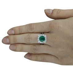 Stamped: 14K Ring Size: 7 Total Ring Weight: 6.3 Grams Emerald Weight: 2.30 Carat (7.40x7.00 Millimeter) Diamond Weight: 0.85 Carat (F-G Color, VS2-SI1 Clarity Face Measures: 13.70x13.75 Millimeter SKU: [600026] Gia Certified Cluster Halo Ring For Formal Occasions, Gia Certified Luxury Cluster Rings, Formal Gia Certified Cluster Halo Ring, Luxury Gia Certified Cluster Rings, Luxury Emerald Cluster Ring With Halo Setting, Luxury Cluster Emerald Ring With Halo Setting, Formal Gia Certified Cluster Ring, Luxury Platinum Cluster Emerald Ring, Formal Cushion Cut Emerald Ring In White Gold