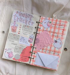 an open planner book with stickers on it