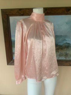 "In great condition! Great pink silky material. Buttons in the back of the neck. 100% polyester  Measurements lying flat: Bust: 20\" Waist: 20\" Length: 22.5\" All sales final. Note: items are described as accurately as possible. All of my items are used unless otherwise stated. Vintage items are sized differently than modern clothing so PLEASE make sure to check the measurements I have provided in order to make the best purchasing decision.  Vintage clothing may show signs of general wear. If there are holes, rips or major flaws I will do my best to mention them in the main description. As always, feel free to ask questions!" Pink Satin Feminine Blouse, Pink Satin Blouse In Feminine Style, Pink Satin Top For Evening, Formal Pink Satin Tops, Elegant Pink Silk Tops, Spring Silk Stretch Blouse, Pink Stretch Elegant Blouse, Feminine Pink Silk Tops, Feminine Pink Satin Top