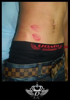 a woman's stomach with red lipstick on it