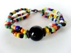 Boho Tibal Multi Colored Three Strand Beaded Large Black Center Bead Bracelet. Love This Bracelet! Large center Black glass Bead!  Measure's  7in L  Perfect Condition!   Sorry No returns. Insurance OR Special shipping request CAN BE ACCOMMODATED please ask before order :) Black Bohemian Beaded Bracelet With Colorful Beads, Black Bangle With Colorful Beads, Black Beaded Bohemian Bracelets, Black Bangle Jewelry With Colorful Beads, Black Round Bead Bracelets For Festival, Black Round Beads Bracelet For Festival, Handmade Black Bead Bangle, Festival Black Bracelets With Large Beads, Handmade Black Bangle Beads