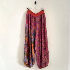 Description: Vintage Nomads 100% Silk Abstract Print Parachute Pants Trousers. Handwash, Marked as Size Small.  Measurementsstrong>Waist: 70cm, Inside Leg: 70cm, Outside Leg: 100cm Baggy High Waist Multicolor Bottoms, Multicolor High-waisted Pants With Elastic Waistband, Multicolor High Waist Pants With Elastic Waistband, Festival Straight Pants With Elastic Waistband, Multicolor Baggy High Waist Pants, Multicolor Relaxed Fit Pants With Pockets, Relaxed Fit Multicolor Pants With Pockets, Multicolor Full Length Pants, Multicolor Wide-leg Pants With Elastic Waistband